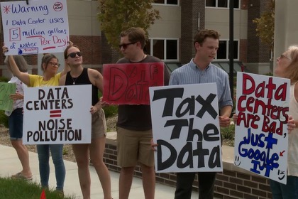 Neighbors holding protest signs in town center